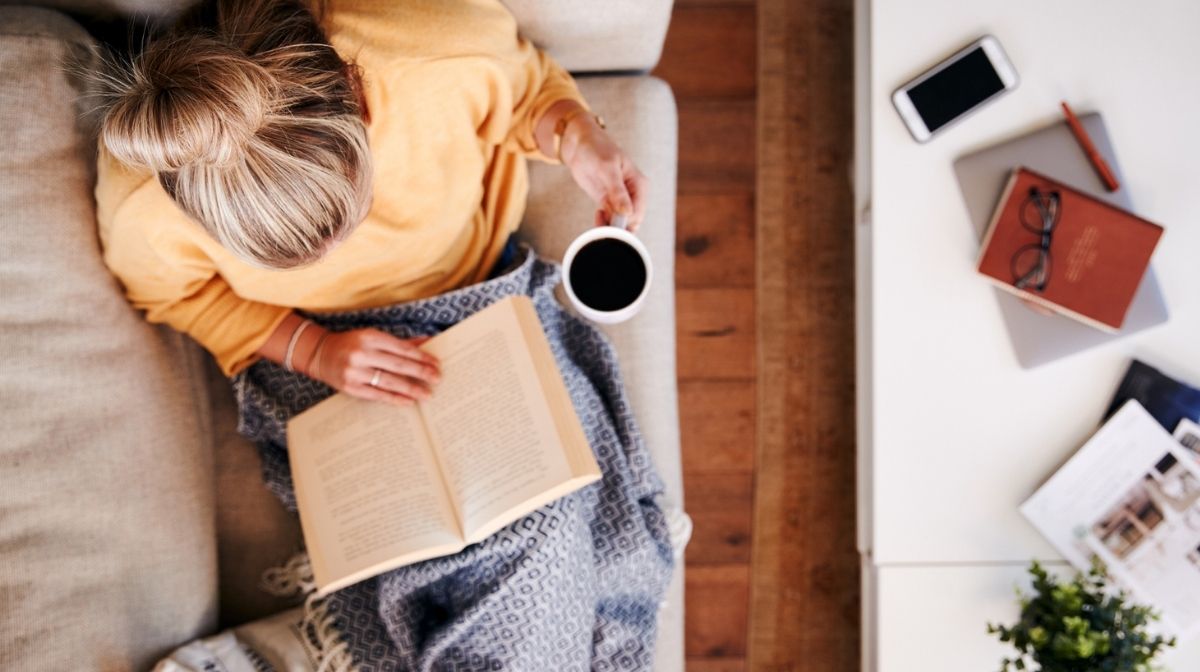 woman relaxing at home alone as part of a self-care routine