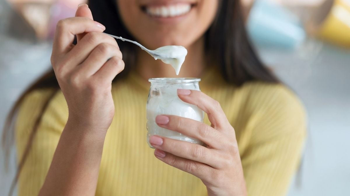 woman eating a probiotic yoghurt
