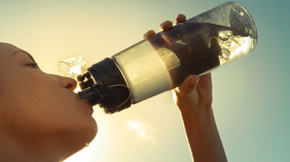 woman drinking water in the sun