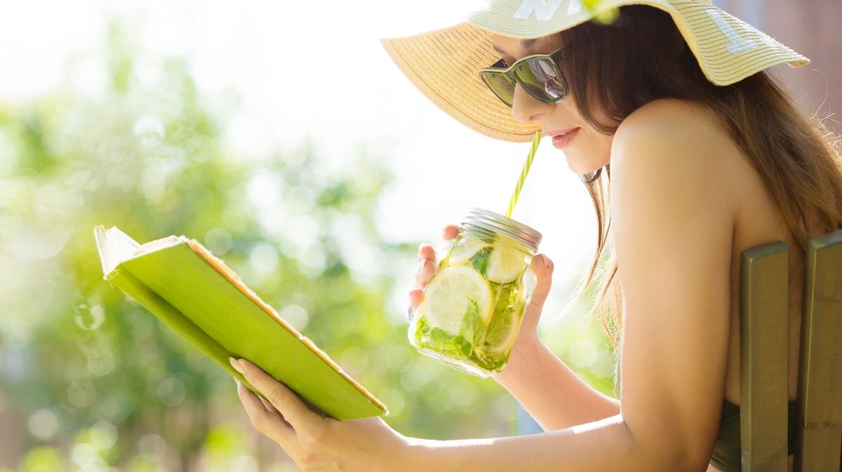 woman drinking infused water in the sun