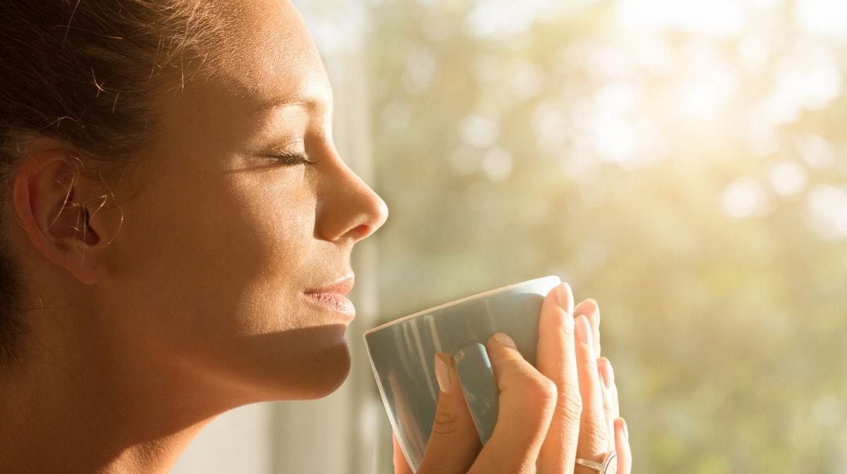 woman drinking coffee in the morning sunlight
