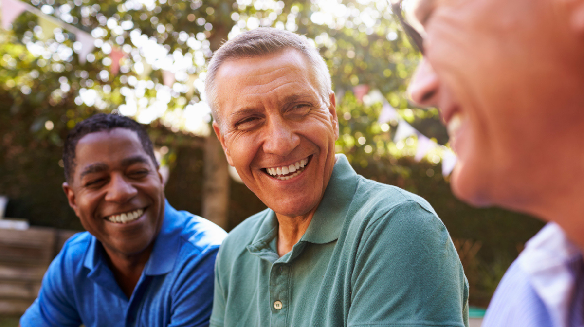 group of male friends over 50 laughing together