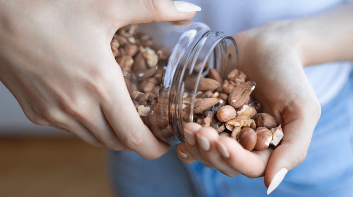 woman holding jar of peanuts