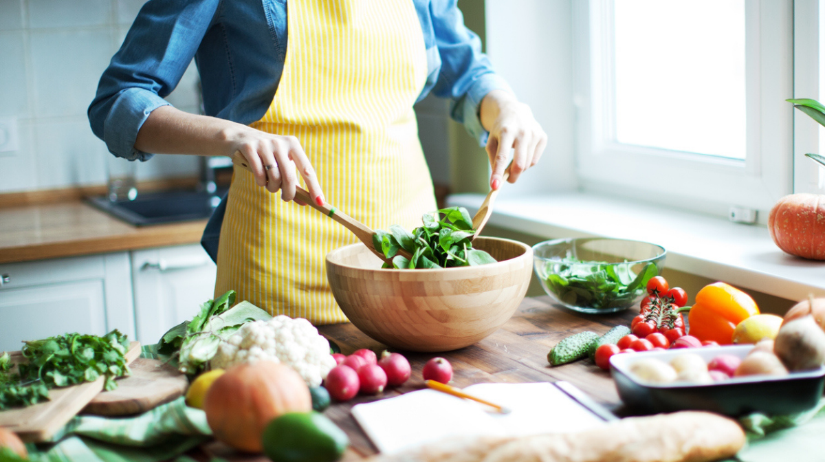 woman preparing leafy greens as vegan source of calcium