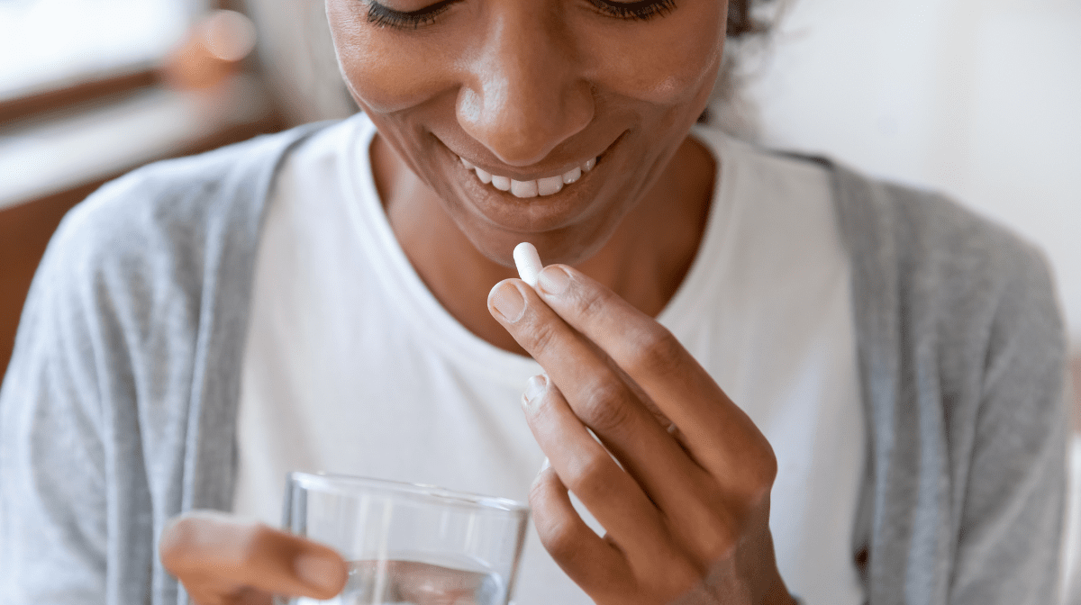 woman taking zinc supplements with water