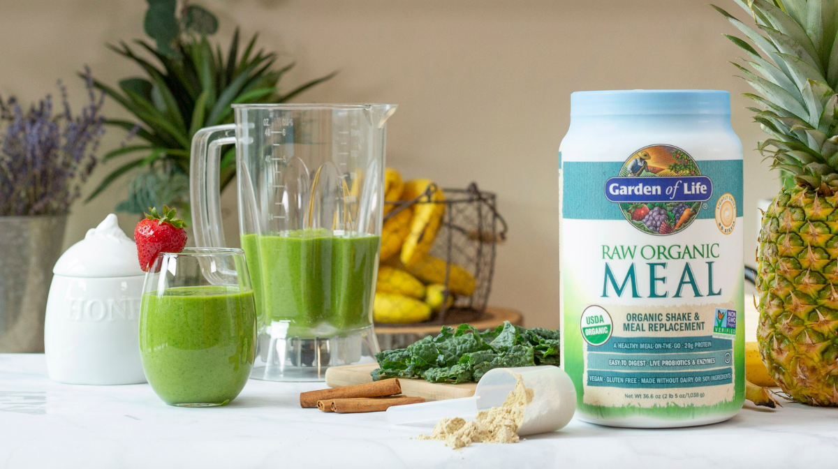 sugar-free protein powder on a table with green smoothie and blender