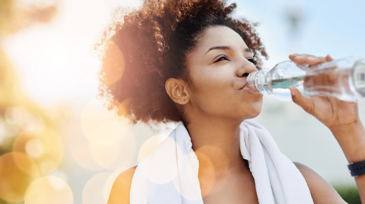 woman drinking water from a bottle