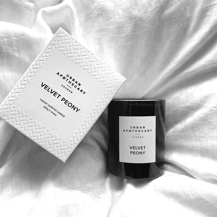 urban apothecary candle on bed