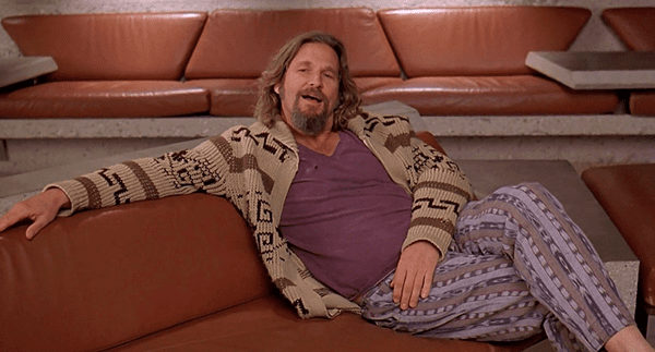 Man in a knitted cardigan sitting on a sofa 