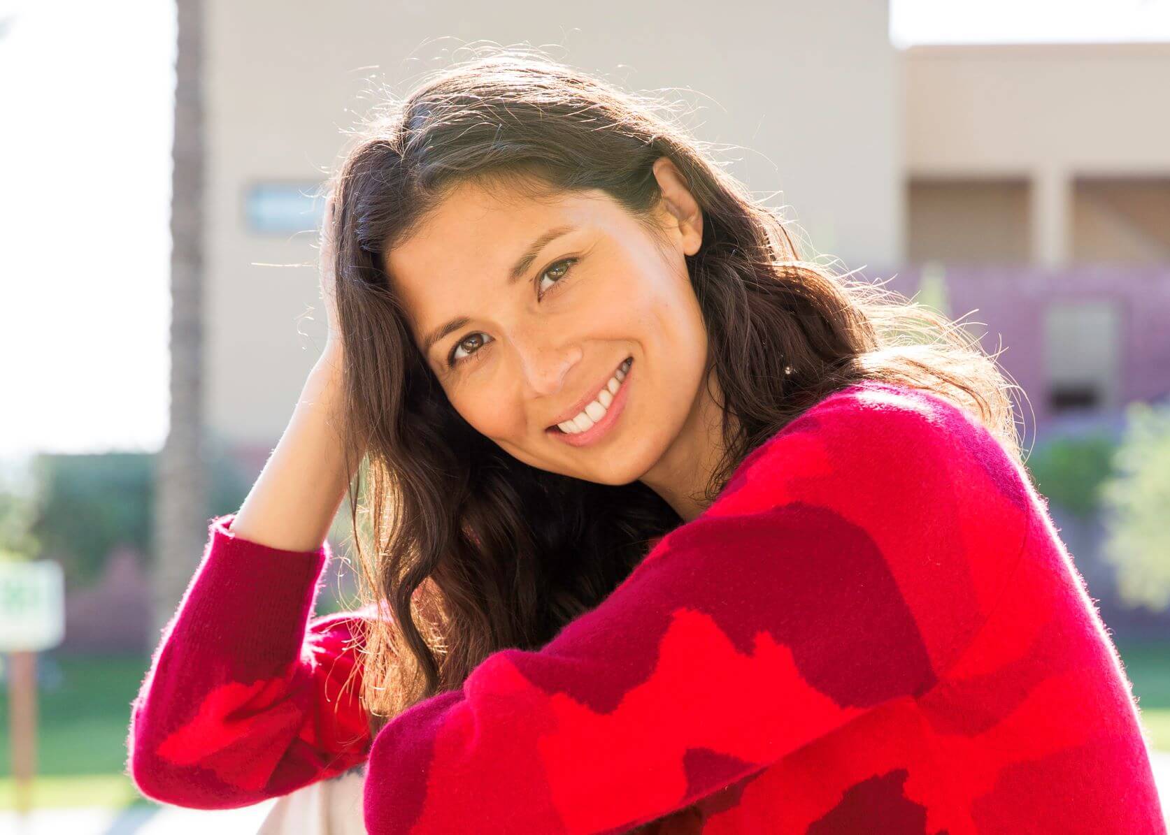 Jasmine Hemsley smiling in a red jumper