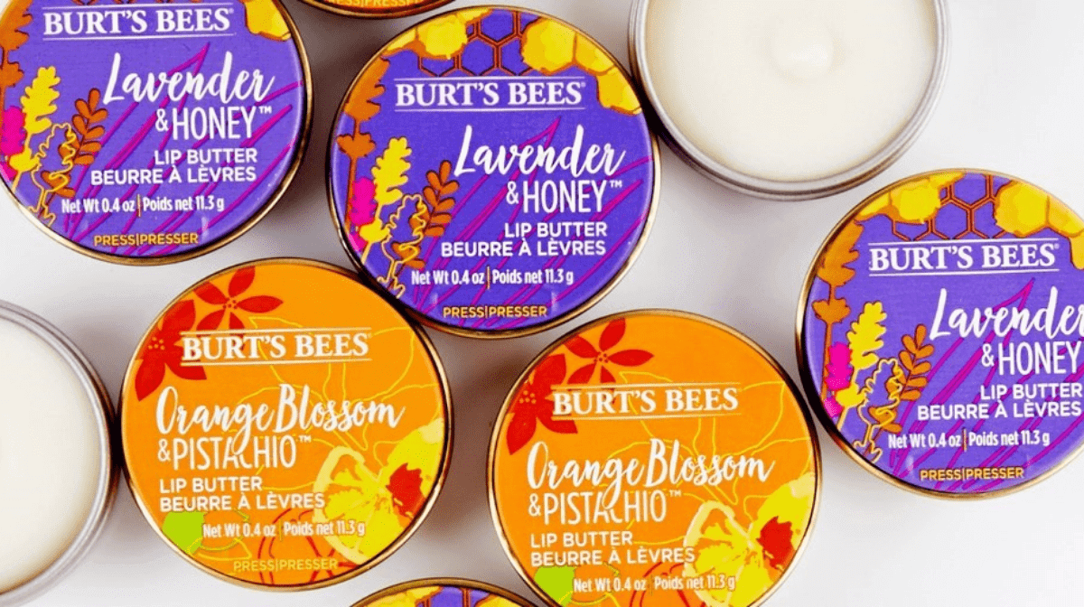 Tins of Burt's Bees Lavender & Honey Lip Butter and Orange & Pistachio Lip Butter which contain Shea butter to nourish your lips