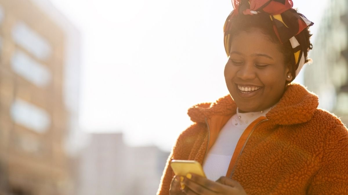 happy woman looking at her phone