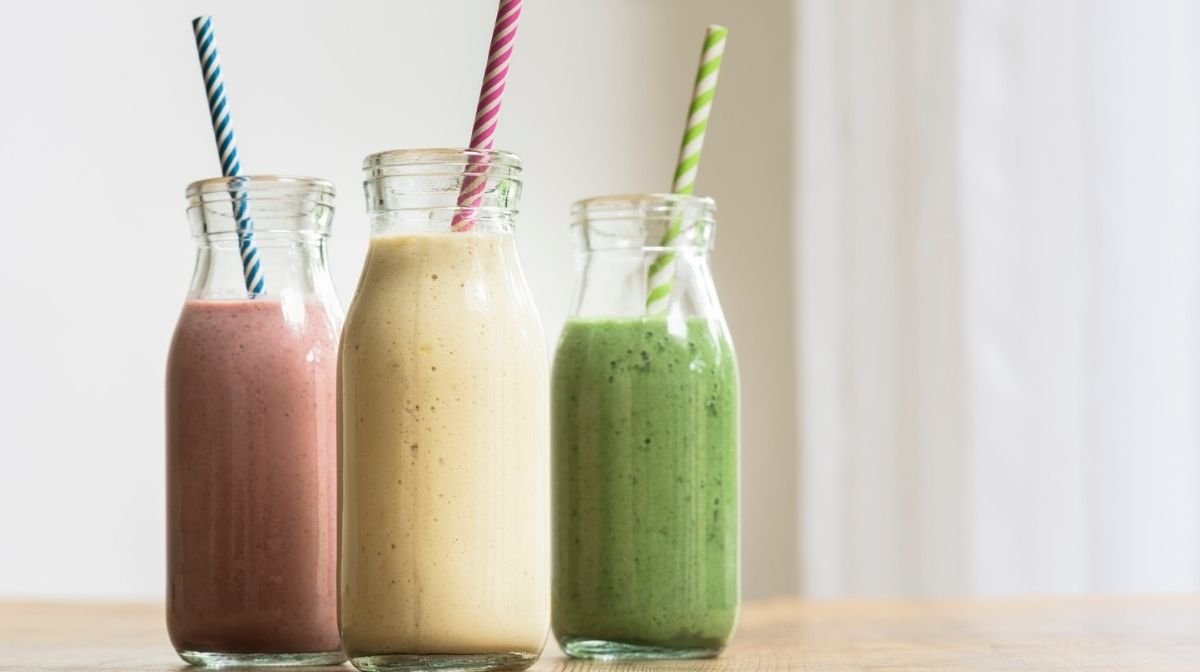 colourful smoothies in milk bottles