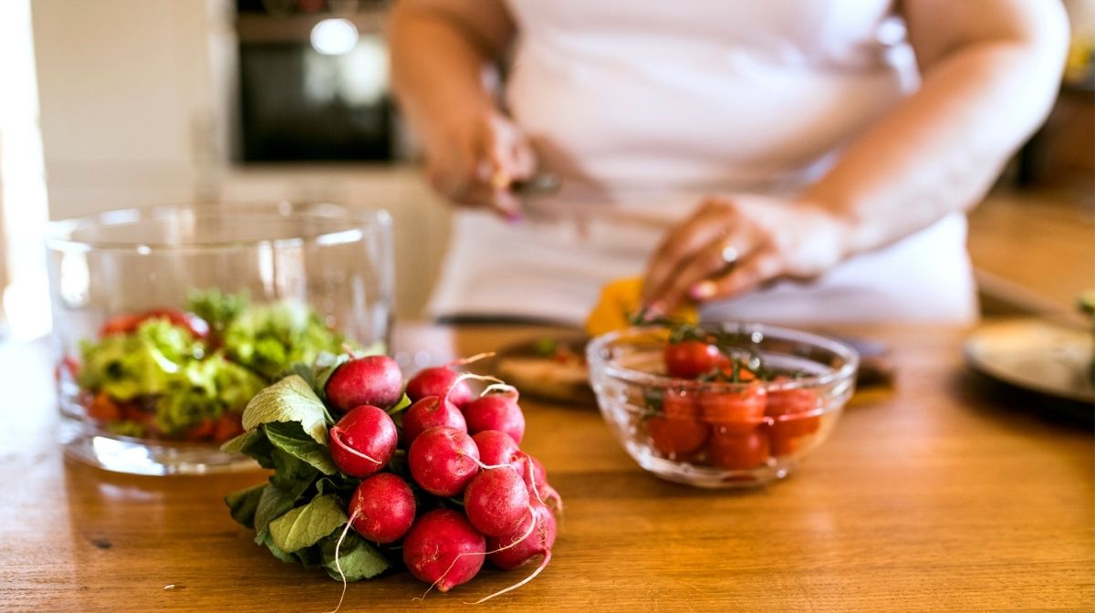 woman preparing salad ingredients