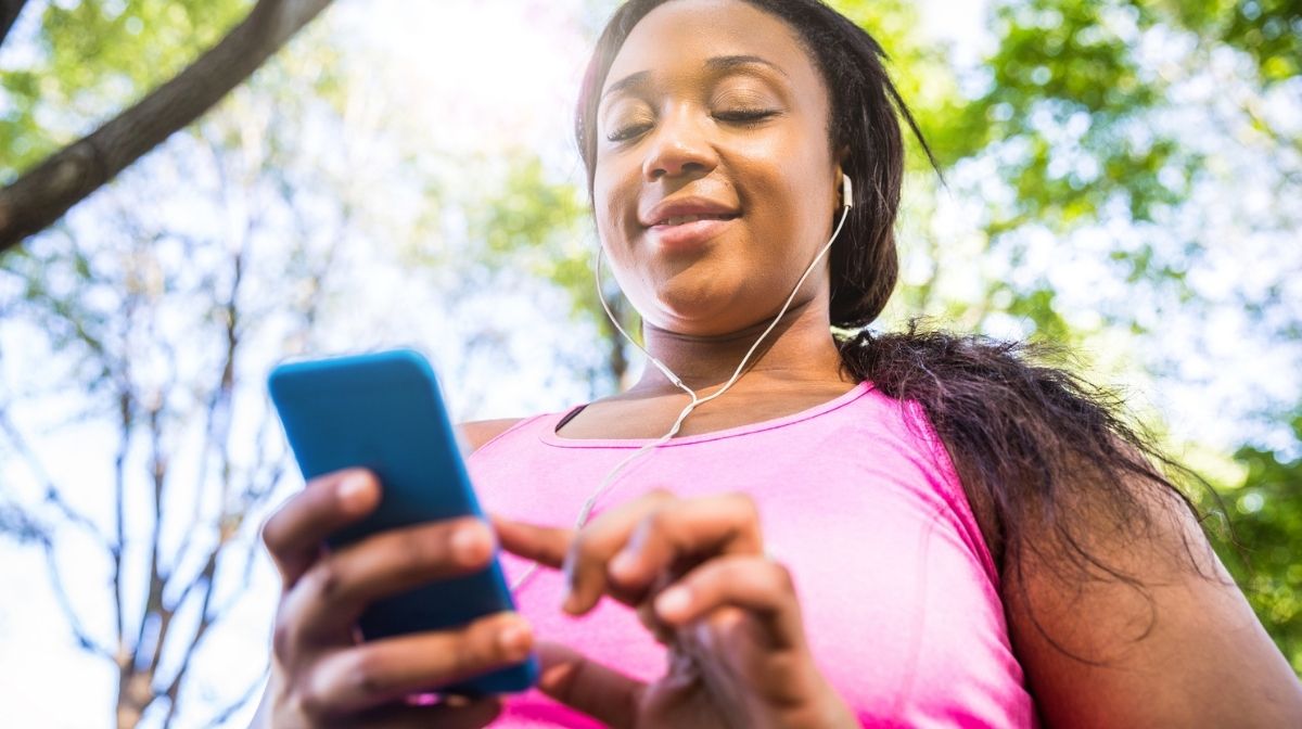 woman listening to headphones while walking