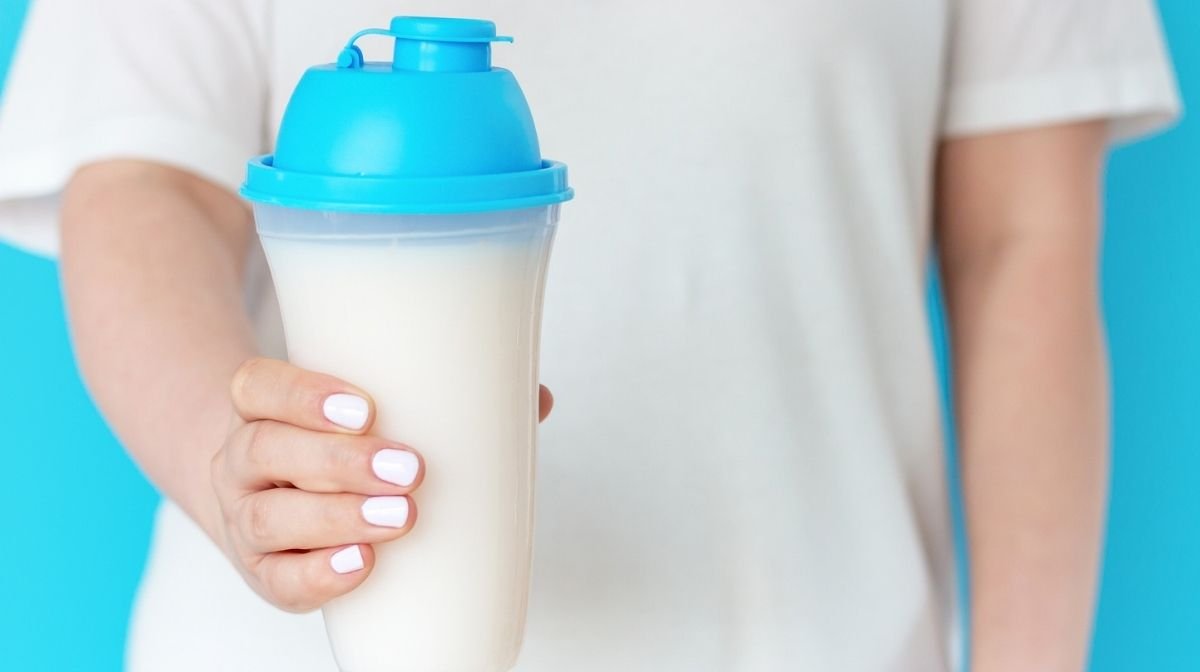 woman holding protein shake