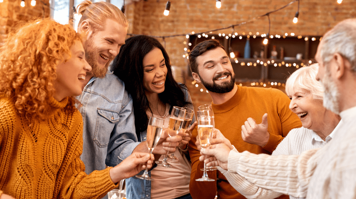 group of friends celebrating new year with glass of prosecco