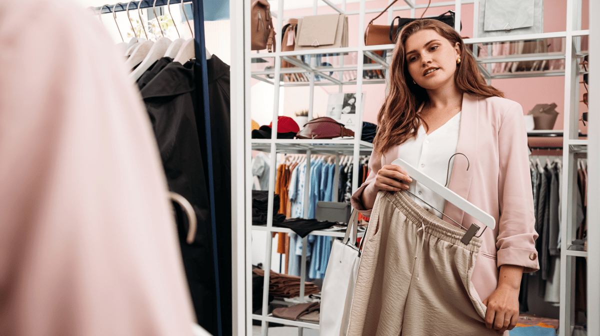 A woman choosing new clothes in the store. 