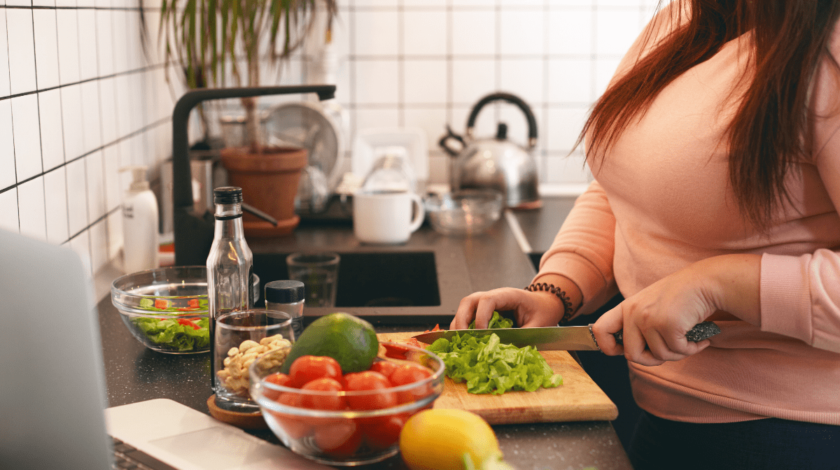 overweight woman cutting vegetables