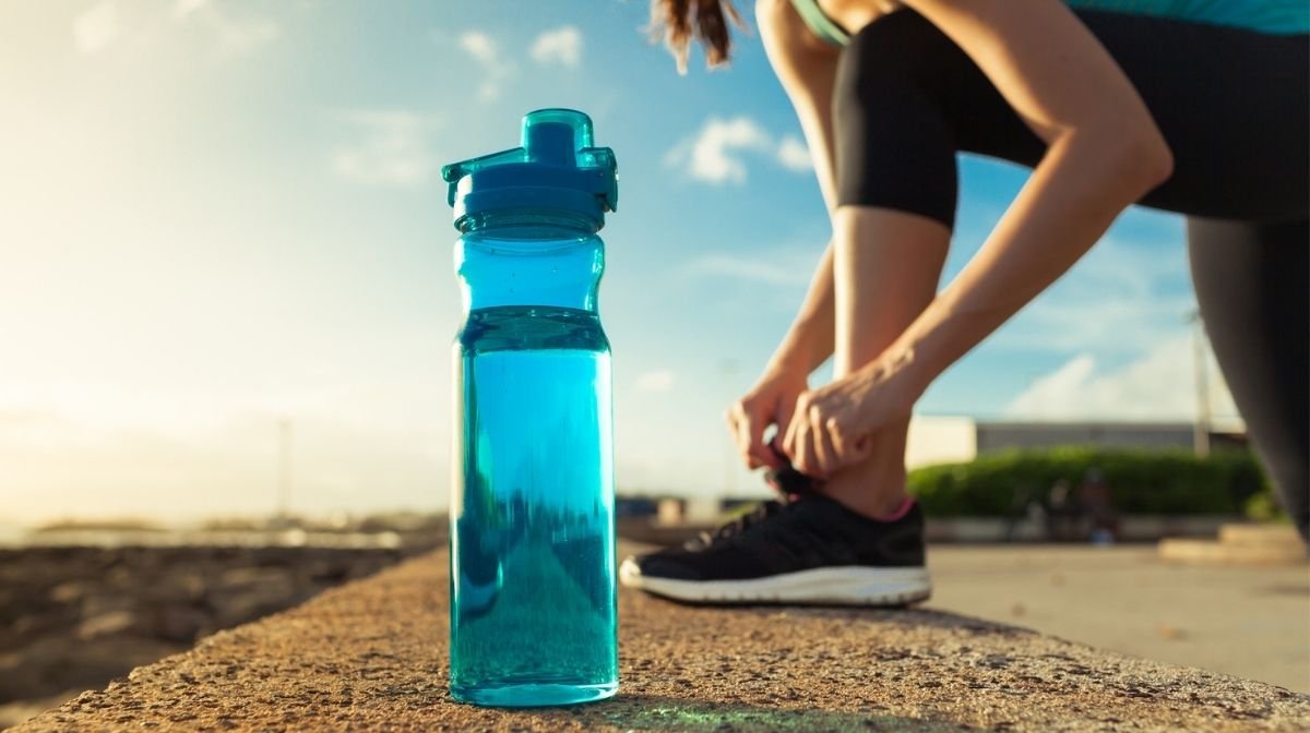 woman with water bottle getting ready to exercise