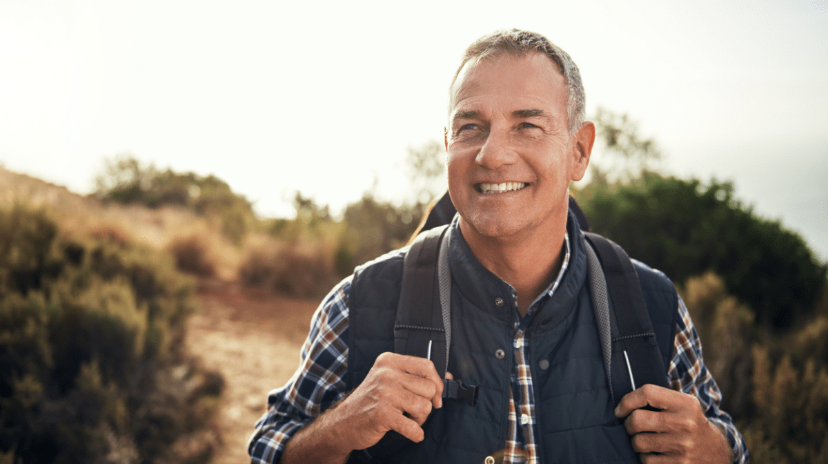 man over 50 happy on a walk outdoors