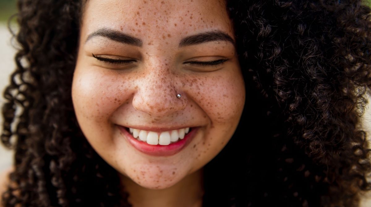 close-up of happy woman's face with freckles