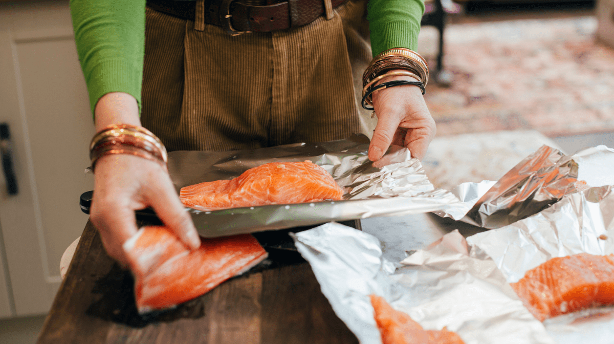 man preparing salmon in the kitchen
