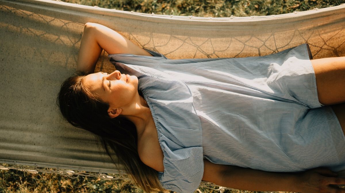 woman sleeping peacefully in a hammock outdoors