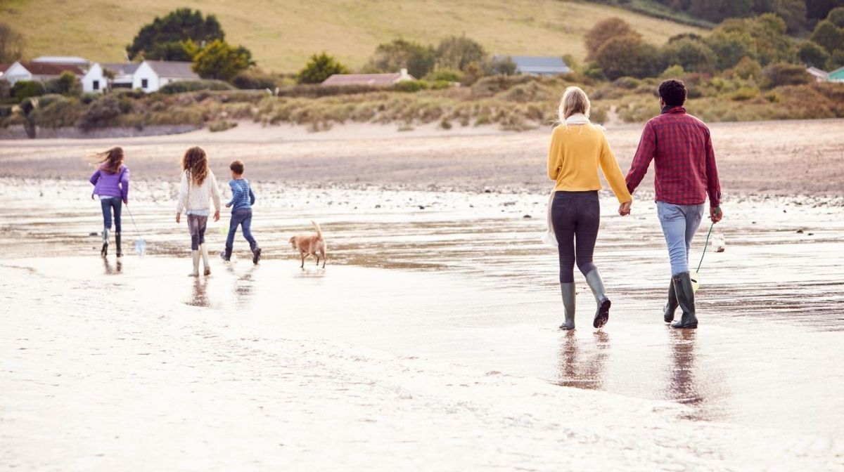family walking along the beach