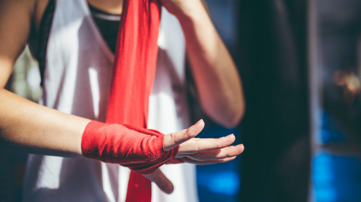 martial arts professional using red hand wrapping