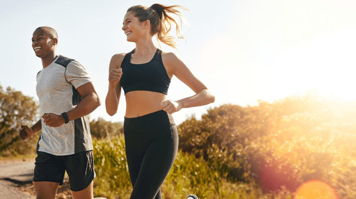 man and woman running together outdoors