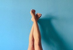 shaved smooth legs in front of blue background