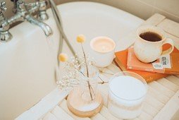 bath with candle and cup of tea