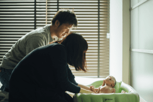 parents with baby bath time 