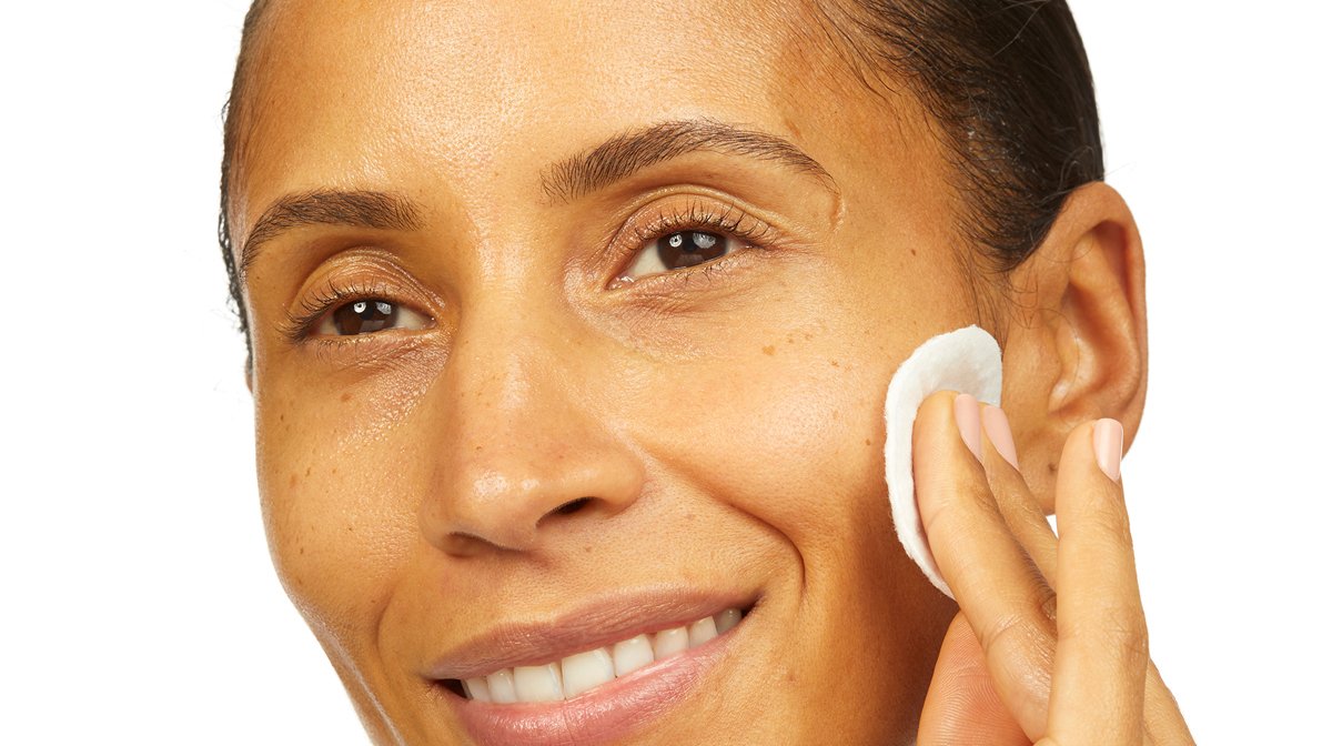 Person cleansing face using cotton pad