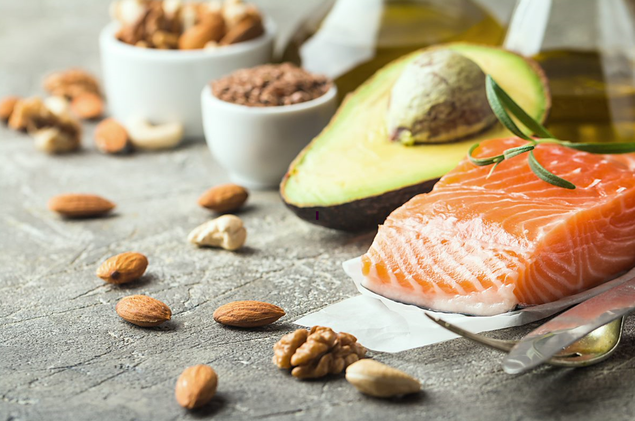 salmon with avocado with nuts scattered across the table