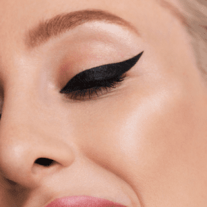 A close-up picture of a woman wearing winged eyeliner