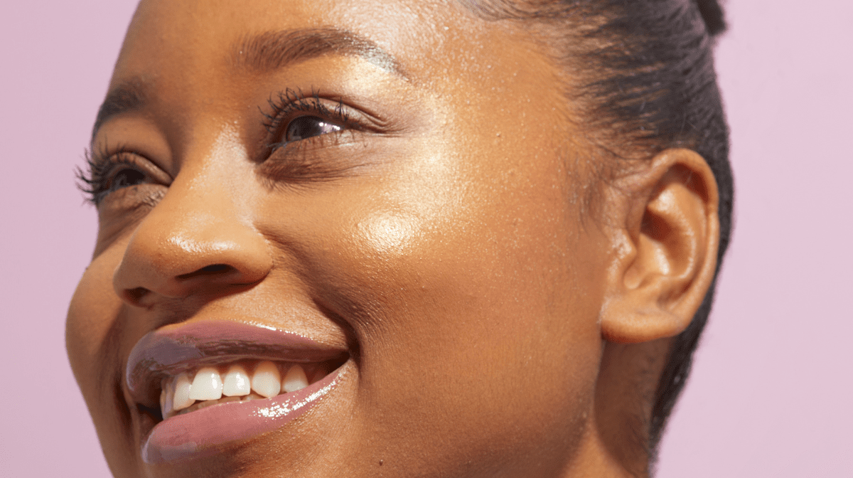 Woman smiling with sunkissed, glowy skin