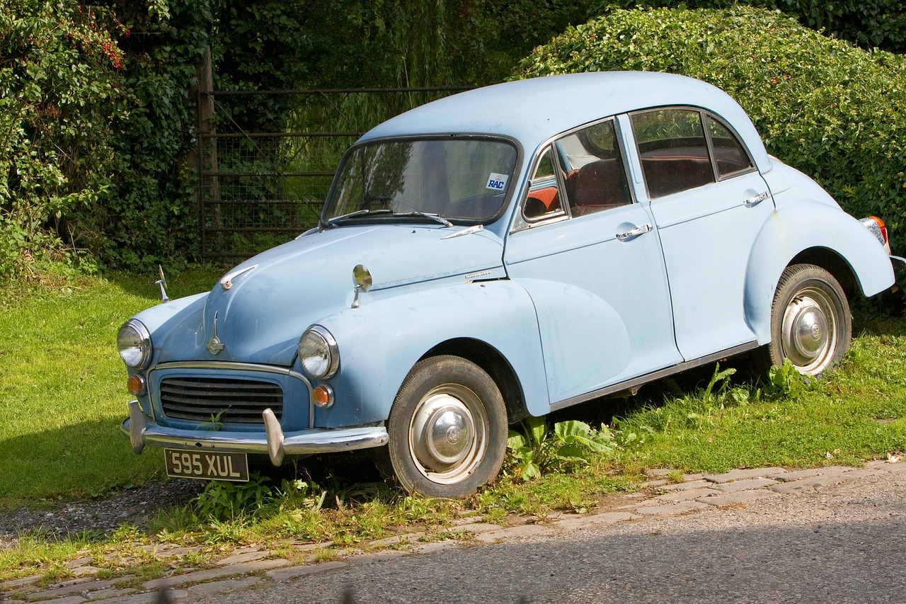 baby blue morris minor parked on grass