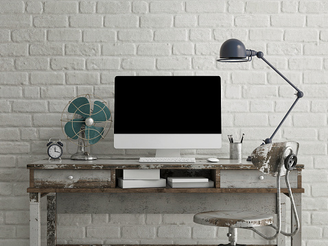 Mock up monitor on table, white brick background