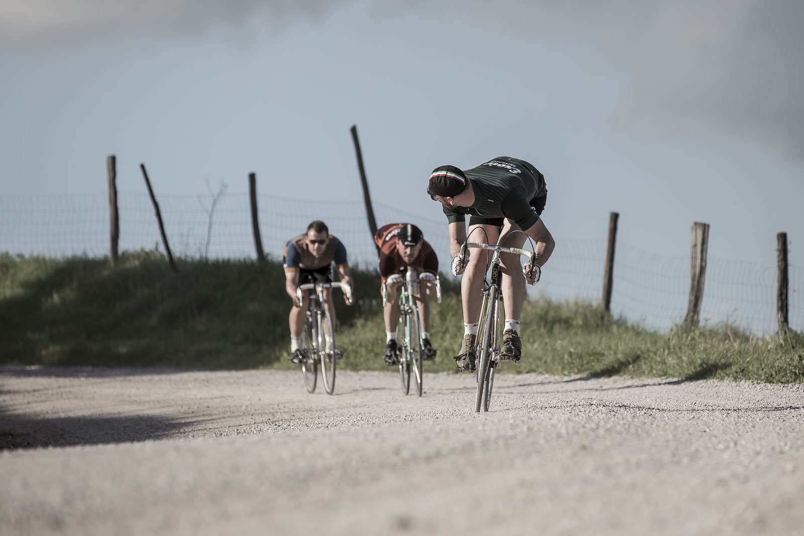 Three cyclists racing in Eroica kit