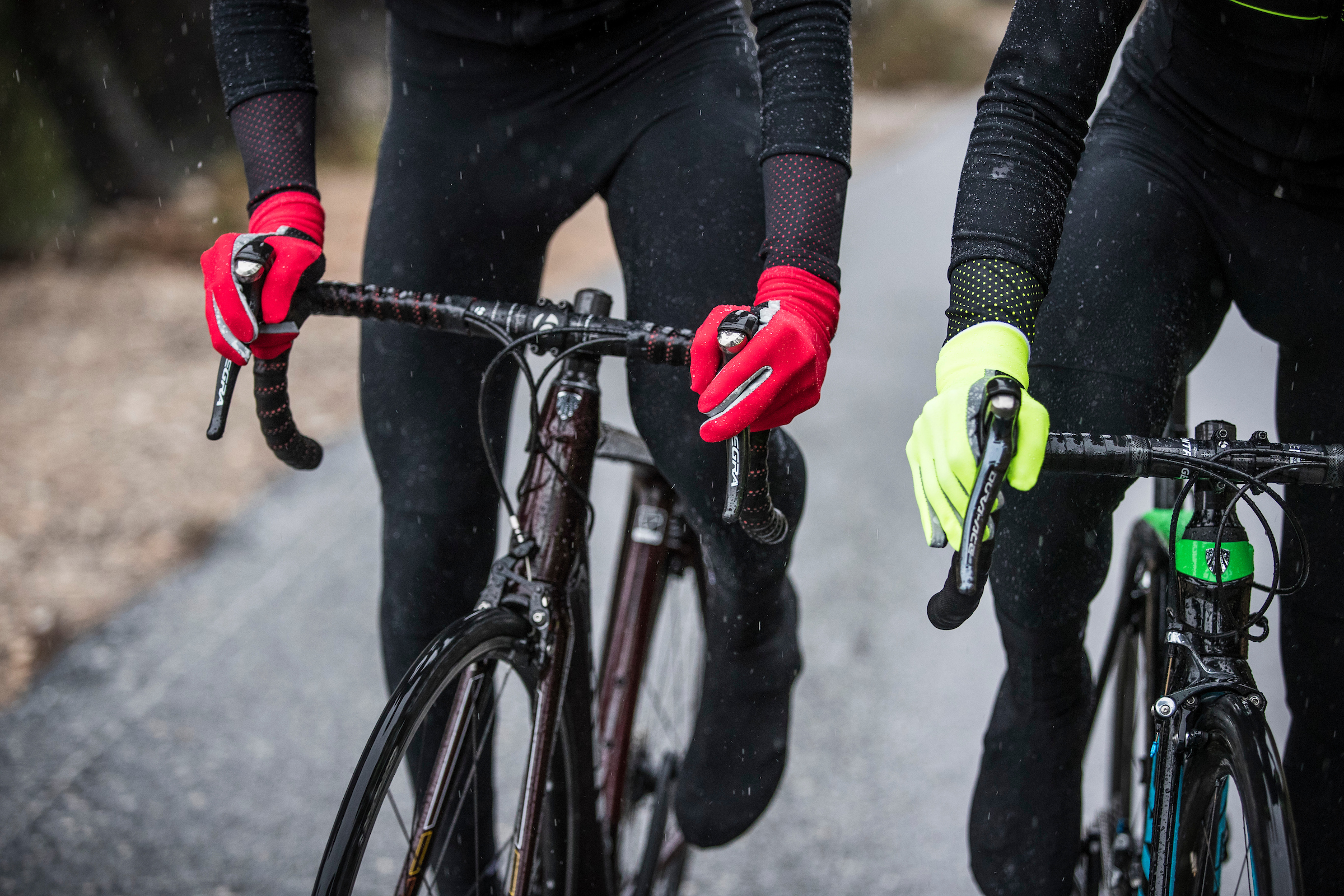 Two riders wearing the santini cycling aquazero gloves