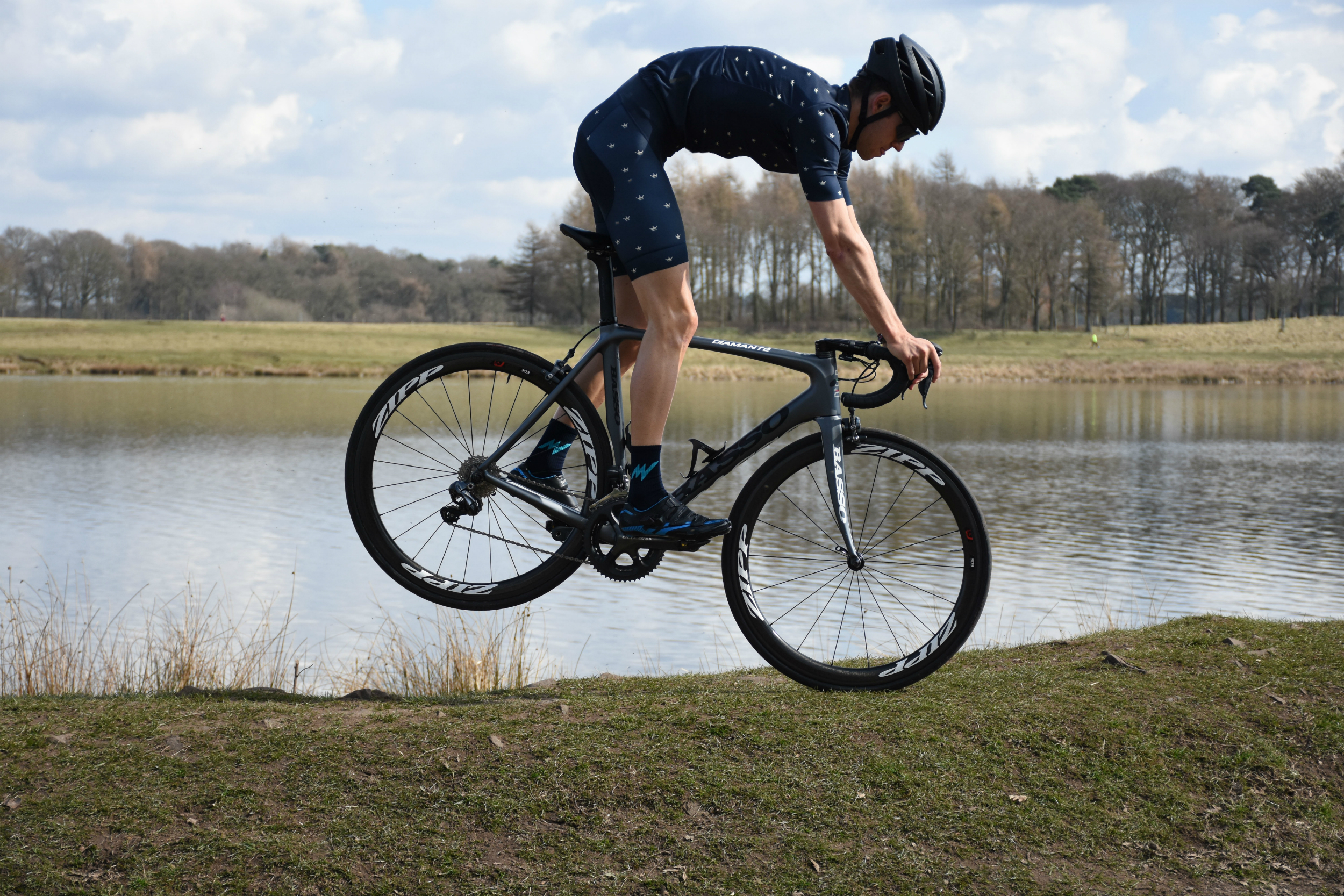 A cyclist doing a nose-stand in the morvelo SS18 KOM range