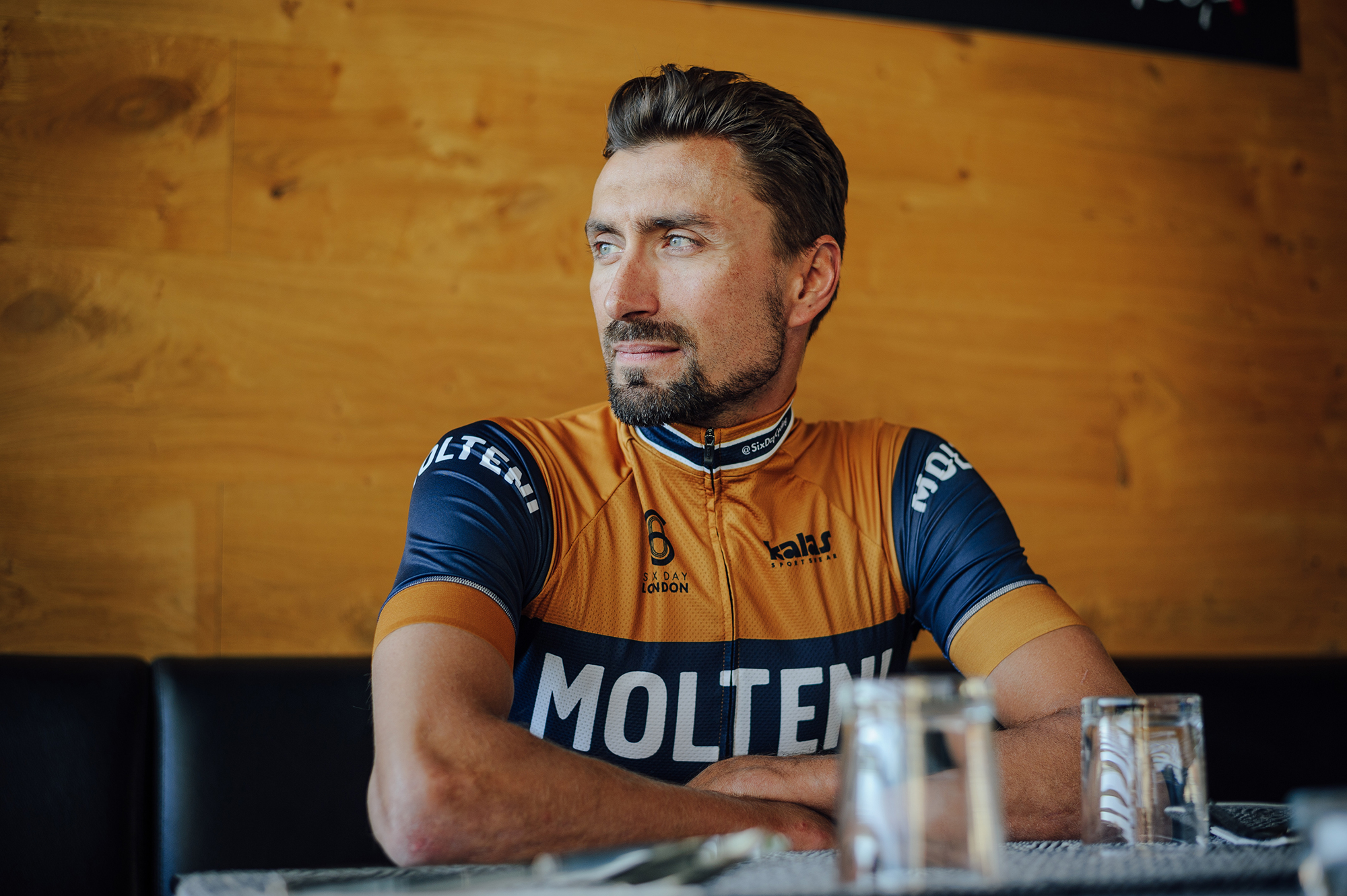 a cyclist sat at a table in the kalas molteni jersey.