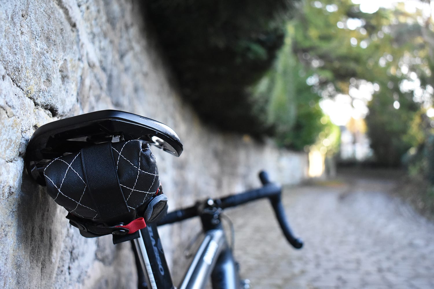 A silca premio seat rollsaddlebag attached to a saddle on a road bike