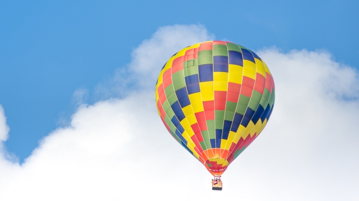 colourful hot air balloon in a blue and cloudy sky