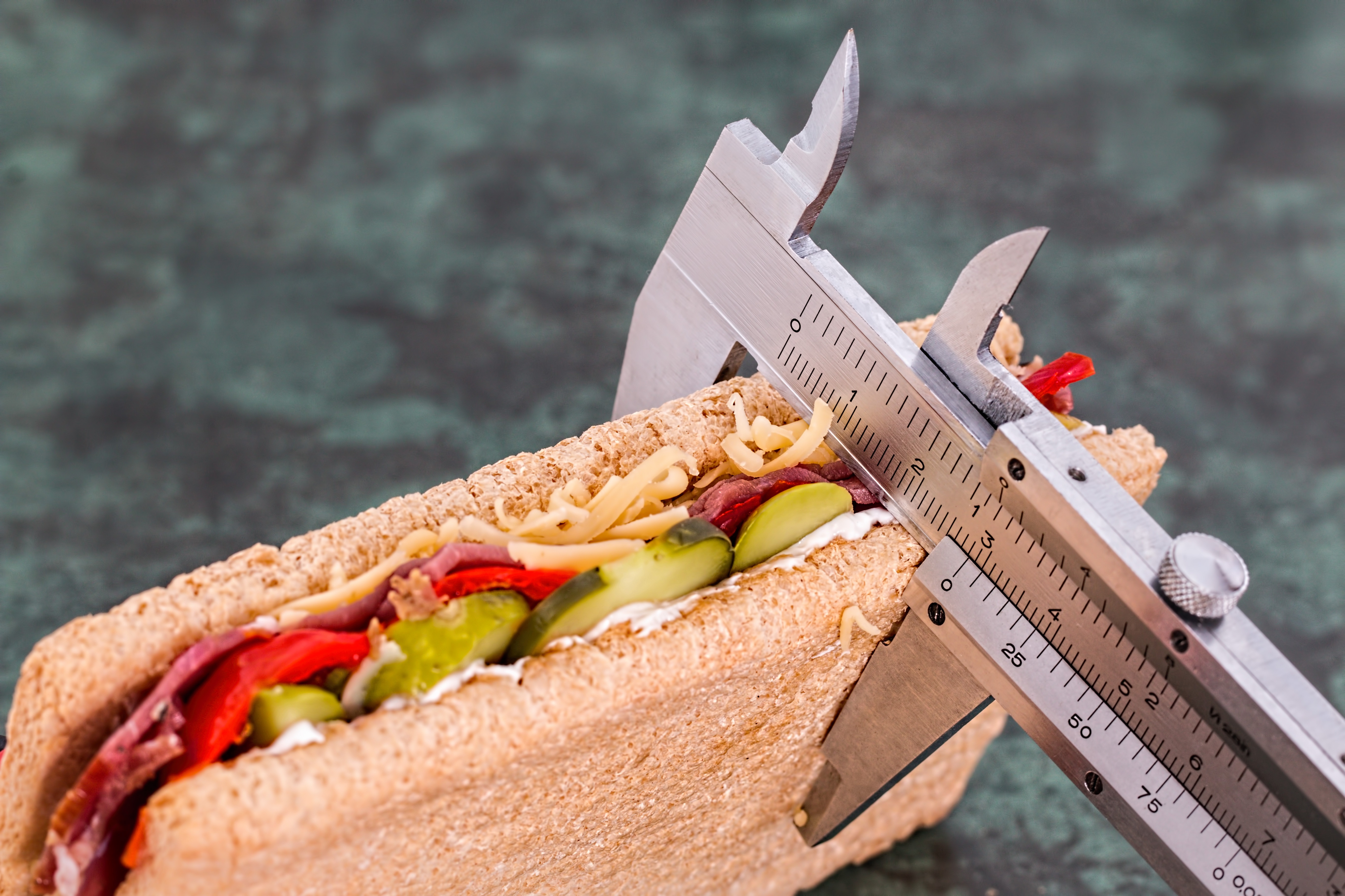 a sandwich being measured