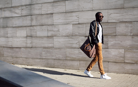 Fashion stylish young african man in city