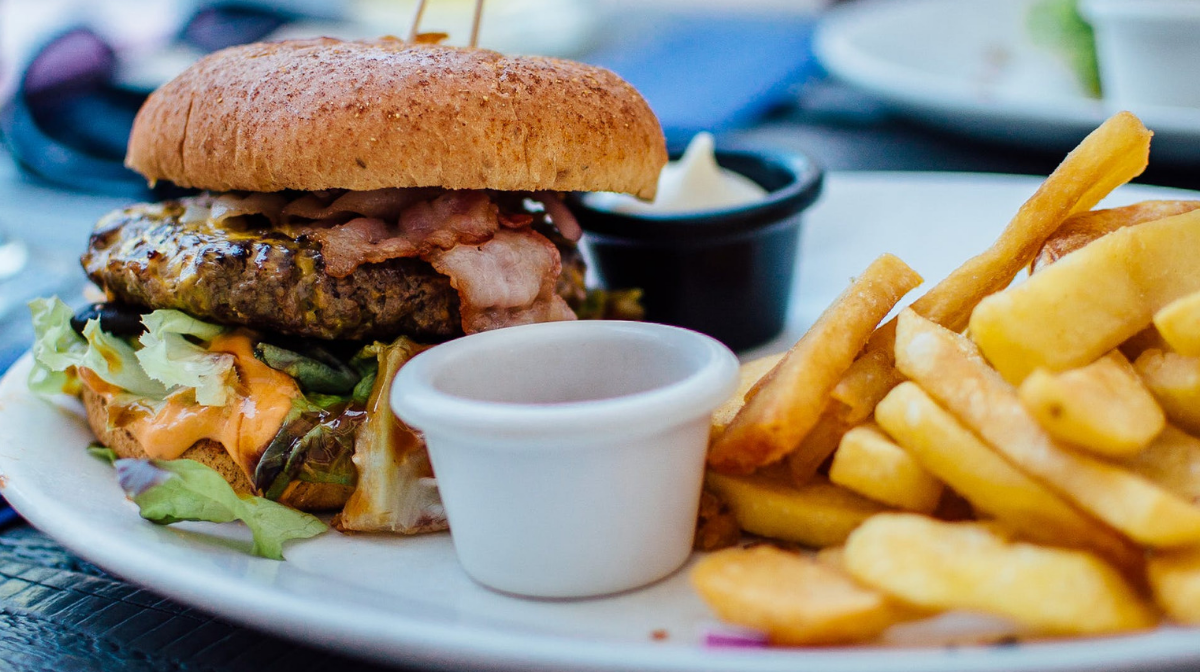 a close up of a burger and chips on a plate