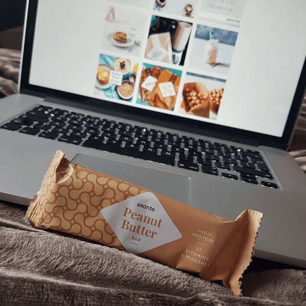 peanut butter bar in front of mac book in bed